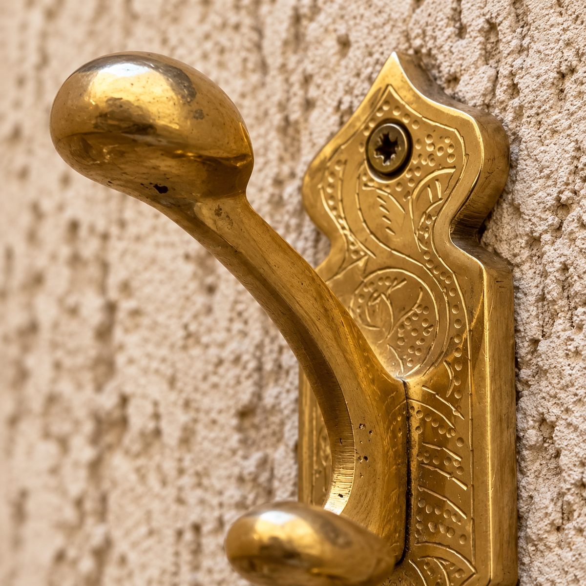Close-up of engraved solid brass Moroccan wall hook craftsmanship