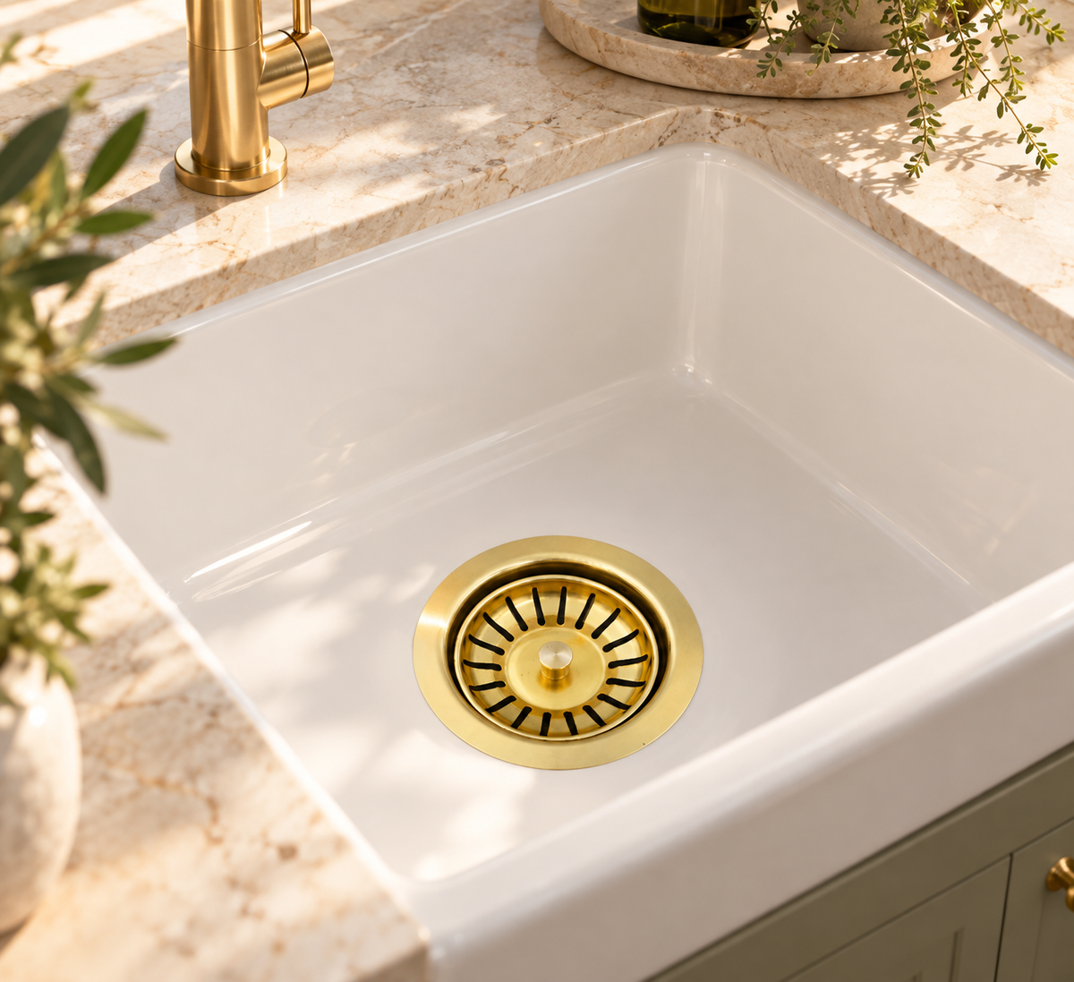 Unlacquered brass basket strainer installed in a luxury Australian kitchen sink