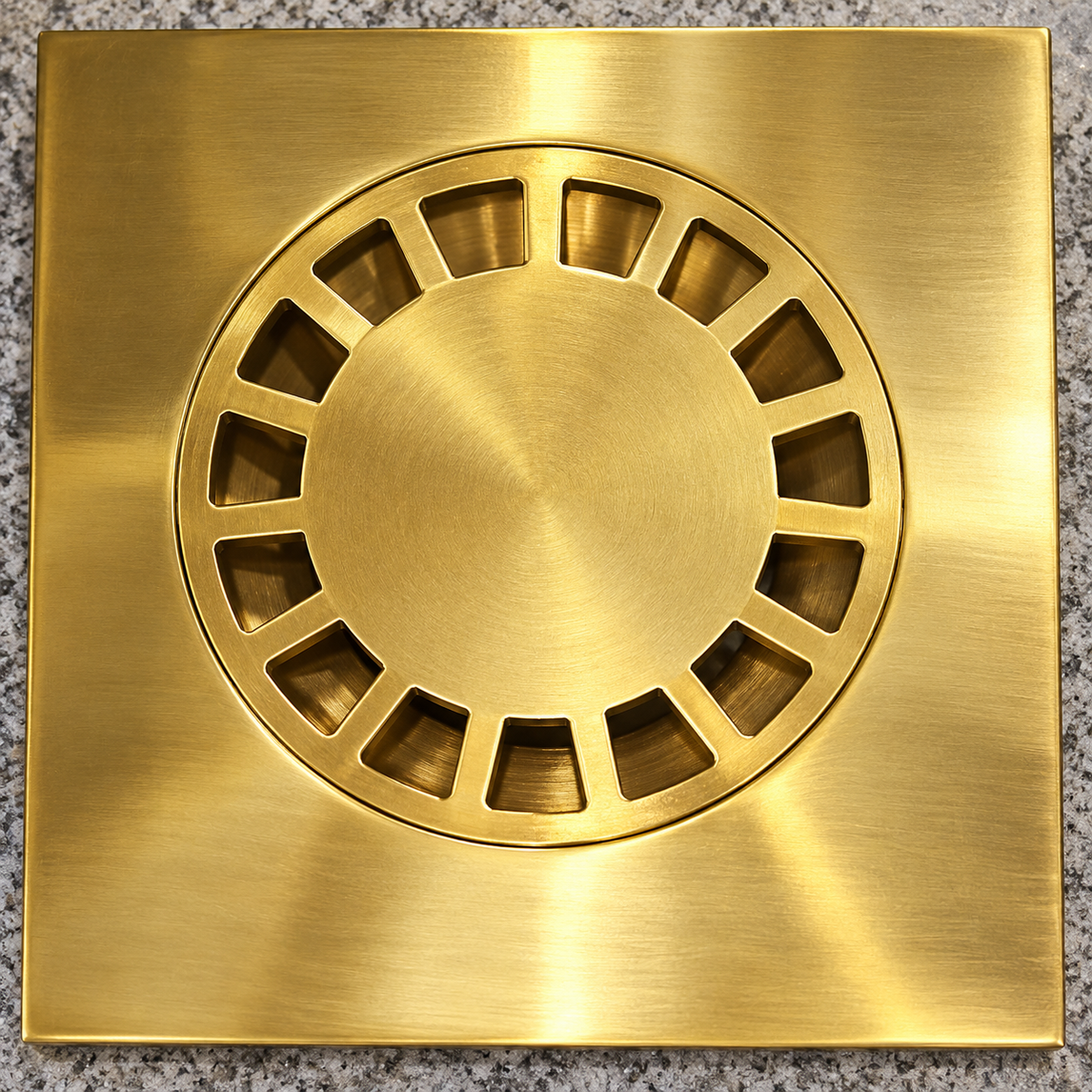 Close-up of removable circular strainer in square solid brass floor drain