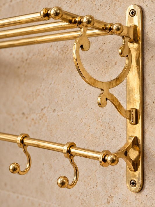 Close-up of ornate handcrafted brass towel rack bracket and hooks