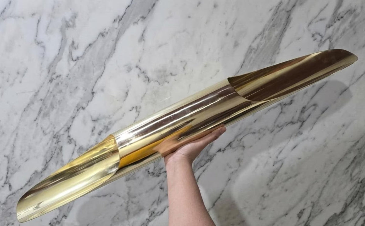 Hand-held view showing the scale and polished brass construction