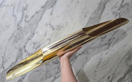 Hand-held view showing the scale and polished brass construction