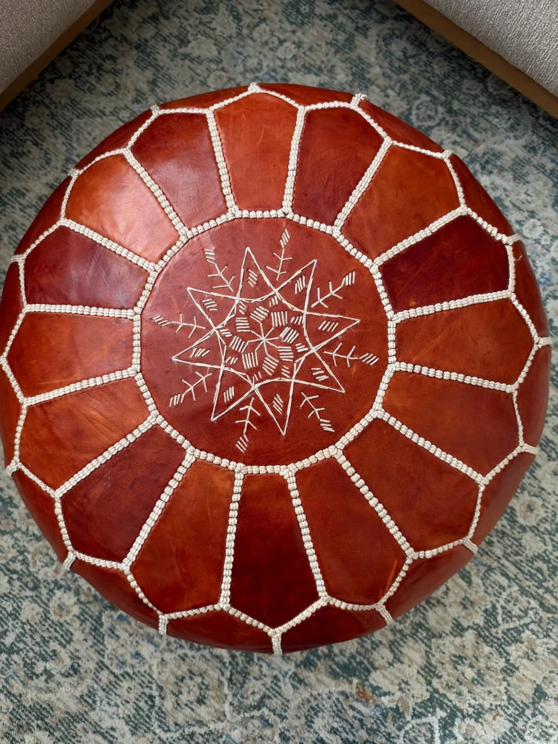 Top view of a cognac brown handcrafted Moroccan leather pouf