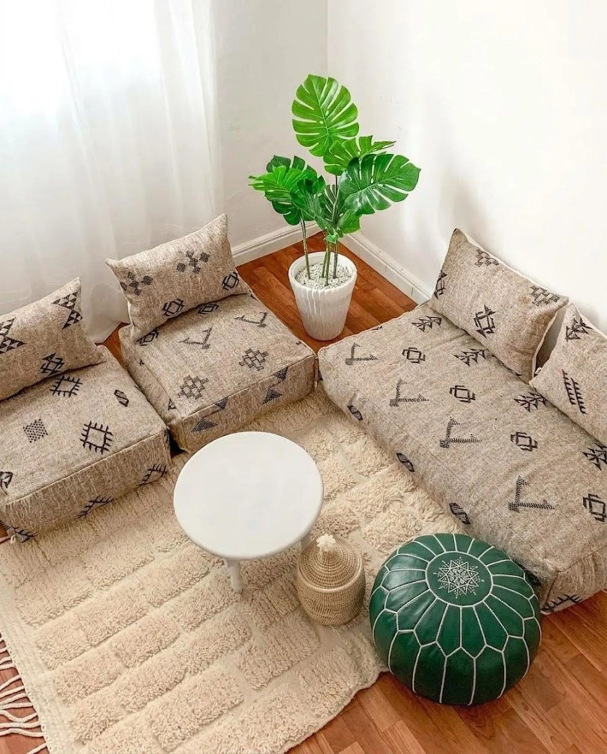 Emerald green Moroccan leather pouf in a relaxed Australian living space