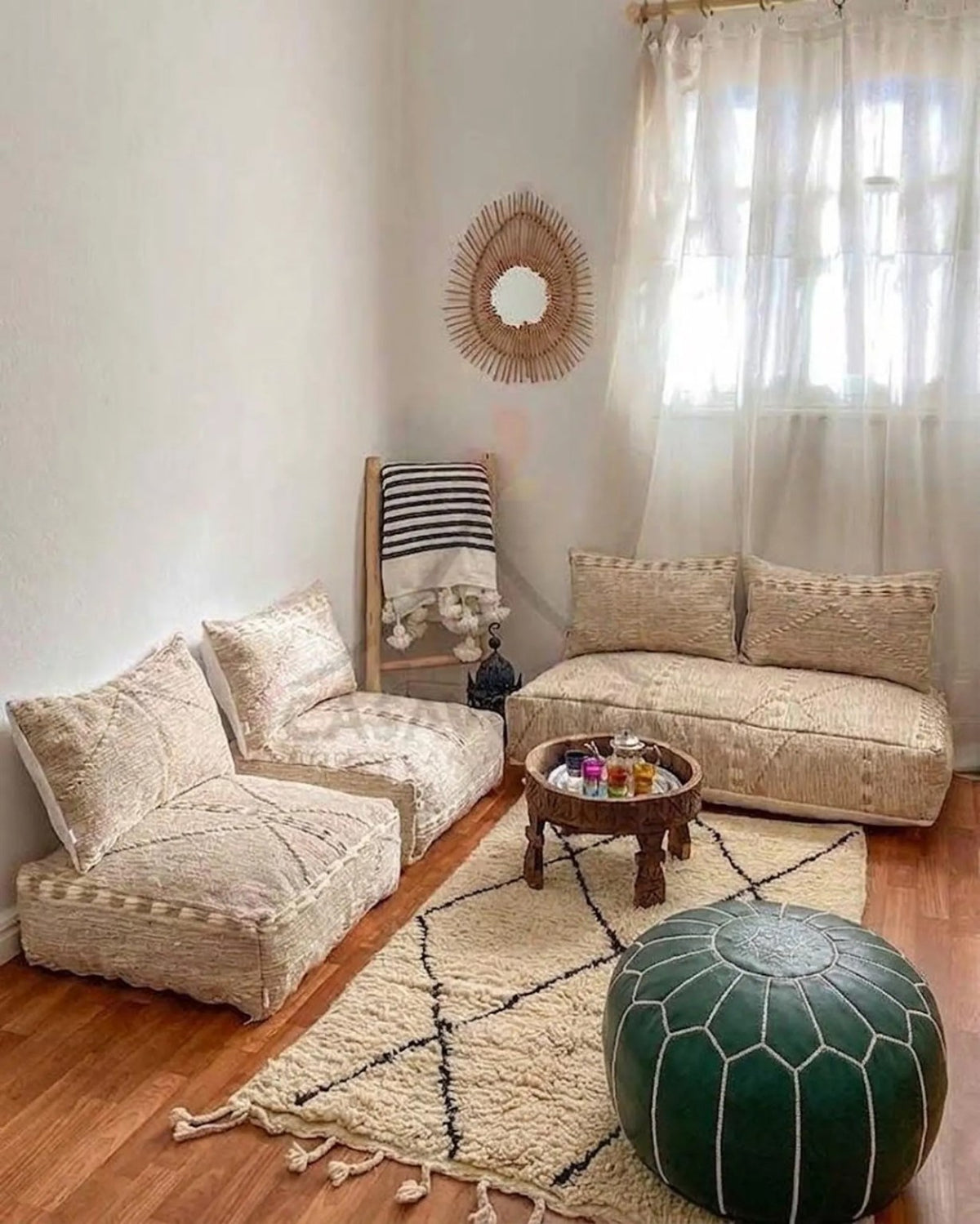 Emerald green Moroccan leather pouf styled in a bright boho living room