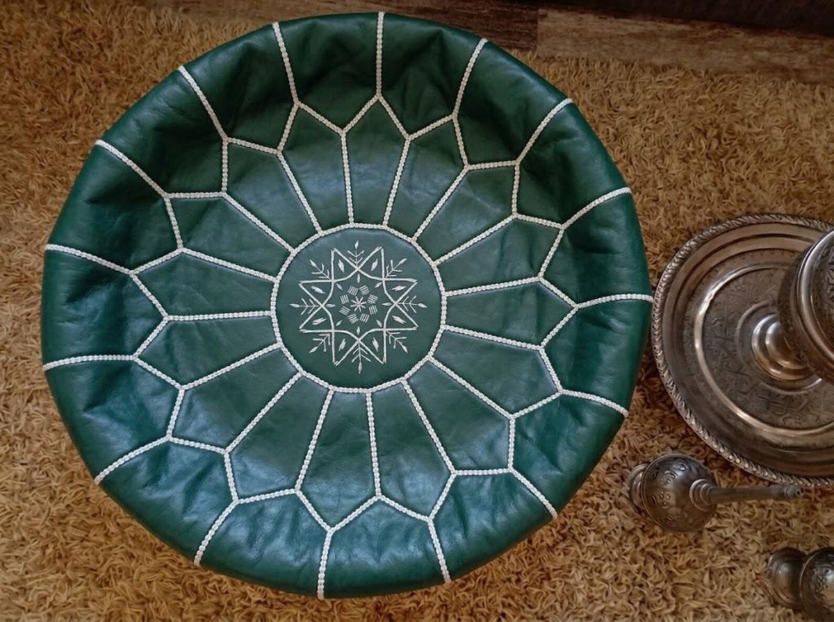 Top view showing ivory hand stitching on an emerald green Moroccan leather pouf