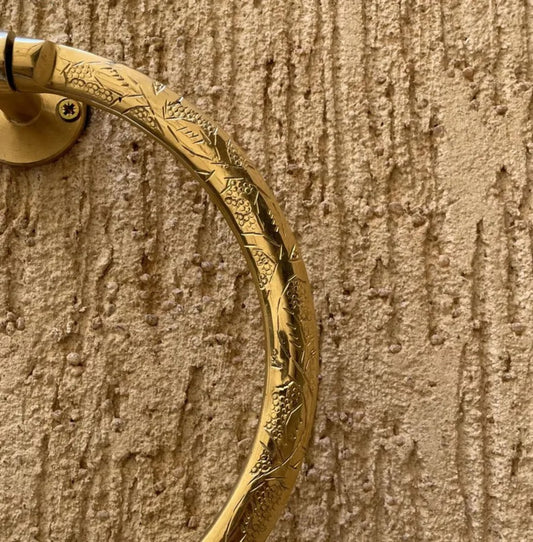 Close-up of hand engraving on solid brass towel ring