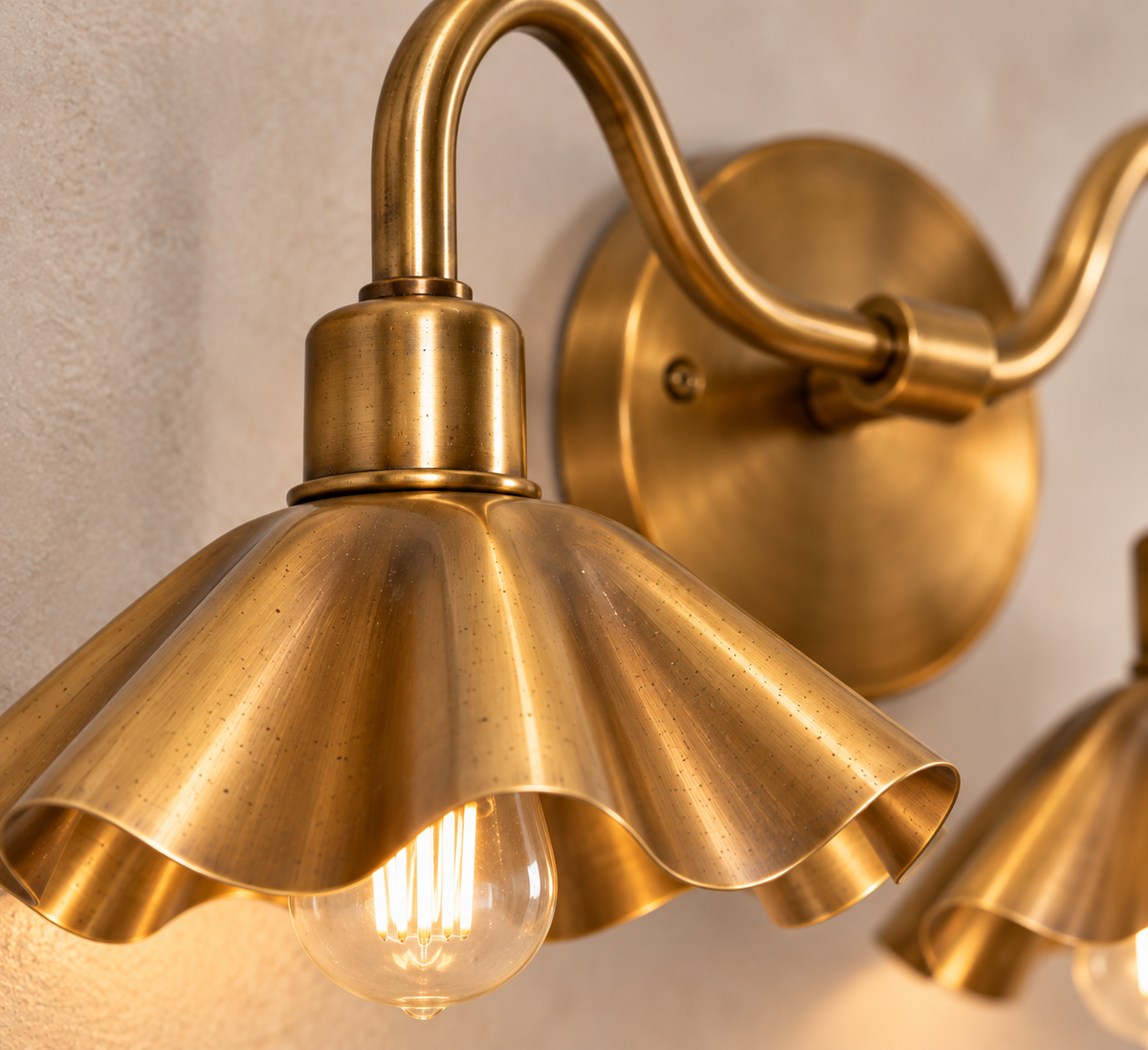 Close-up detail of handcrafted brass petal shade and curved arm
