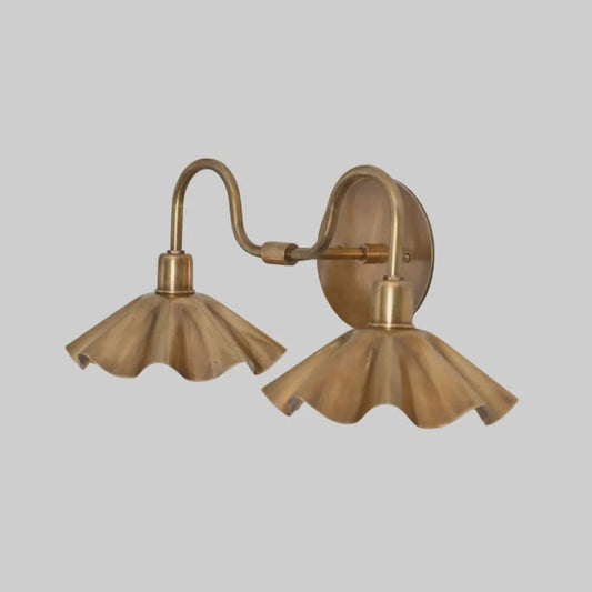 Angled view of handcrafted brass double petal wall light