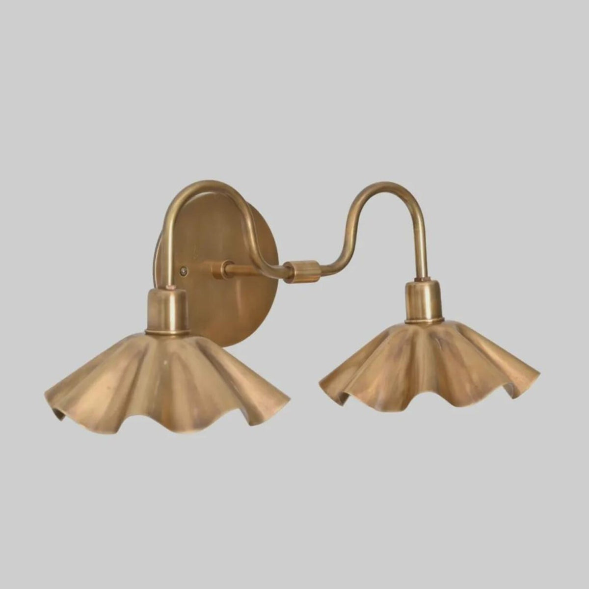 Side angle showing curved brass arms and petal shades