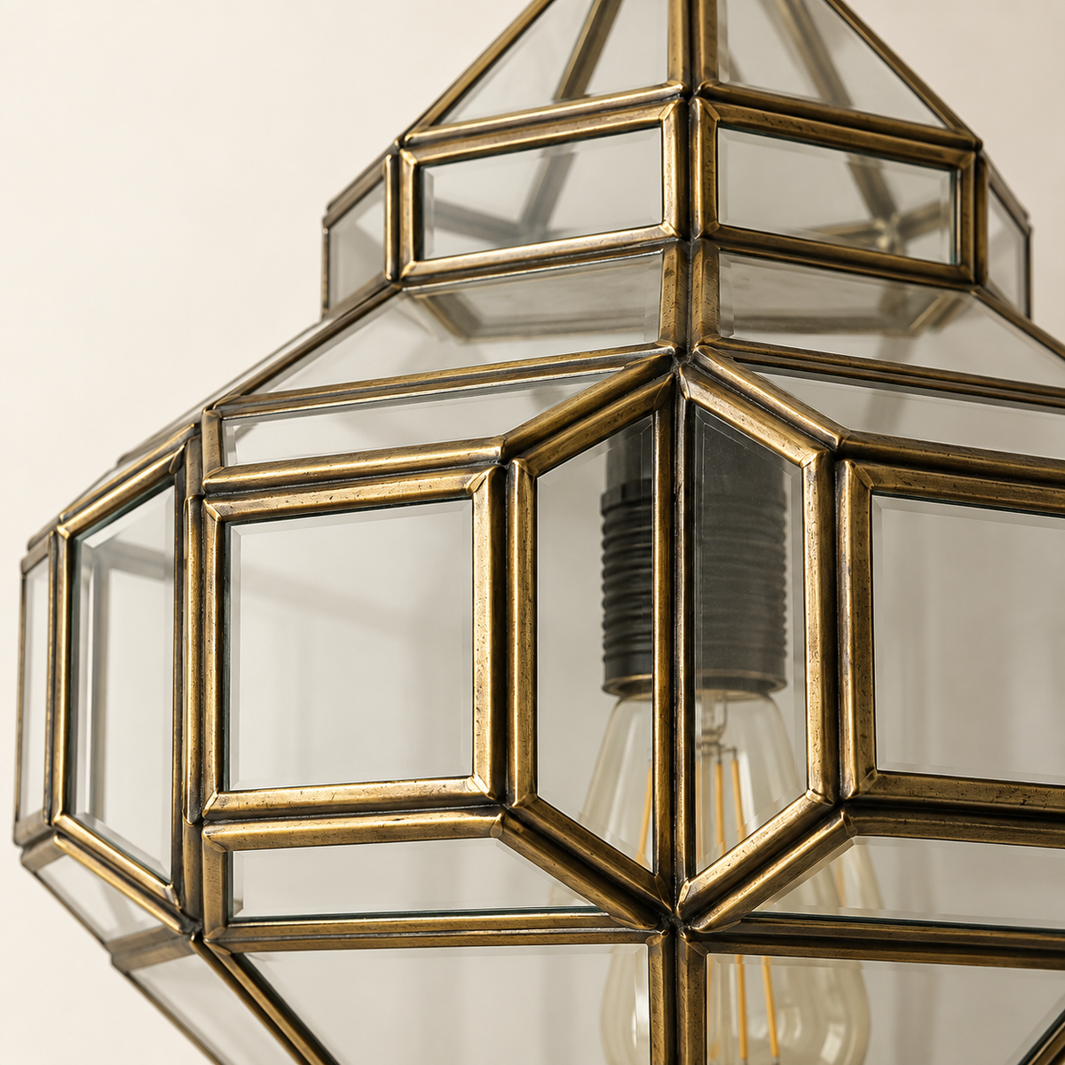 Close-up of handcrafted antique brass frame and clear glass panels