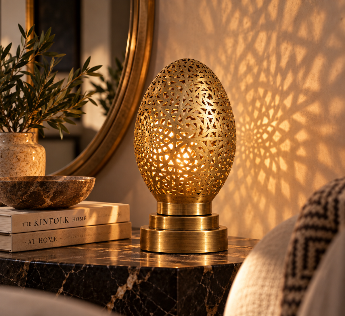 Moroccan pierced brass egg table lamp in luxury interior with patterned light