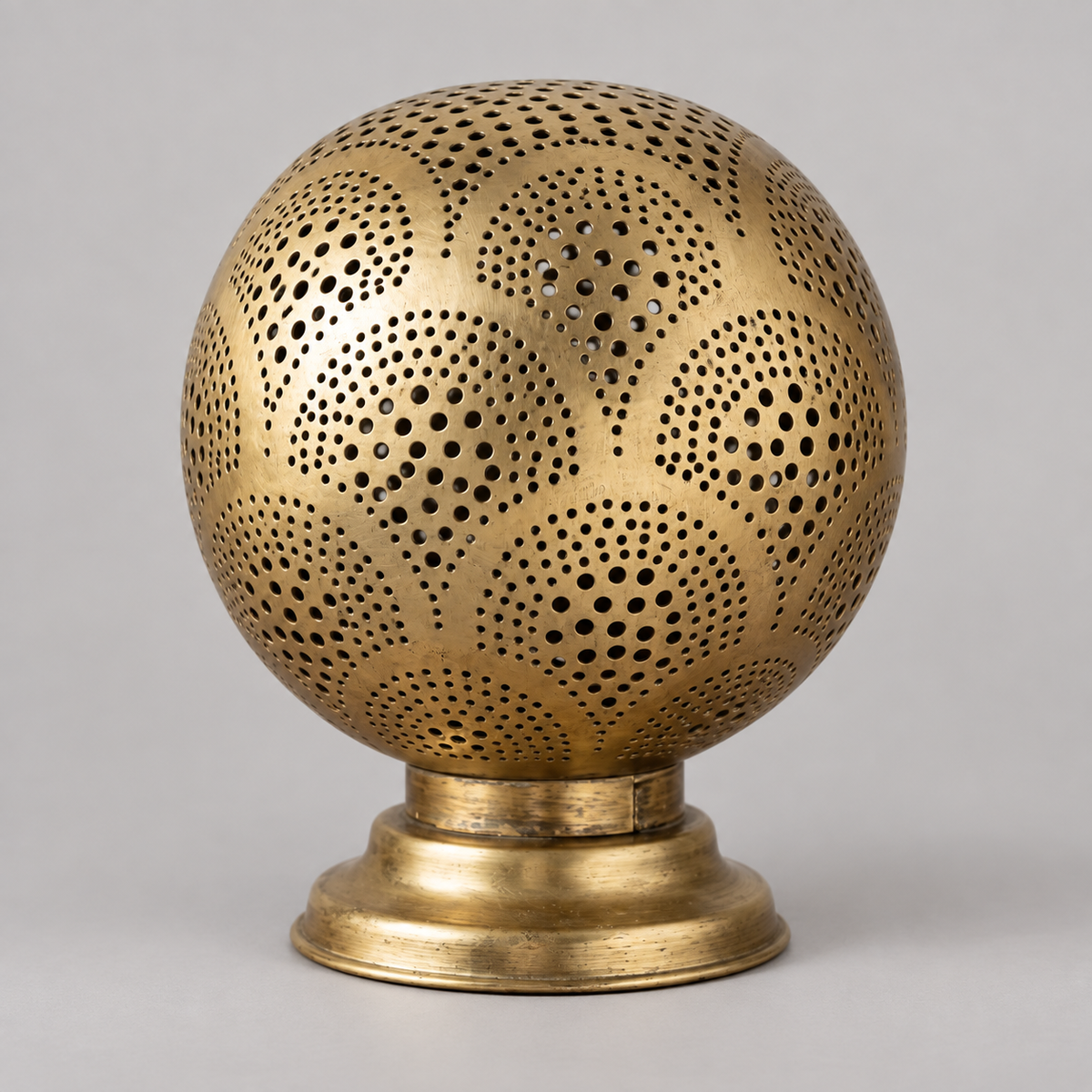 Unlit Moroccan pierced brass globe table lamp