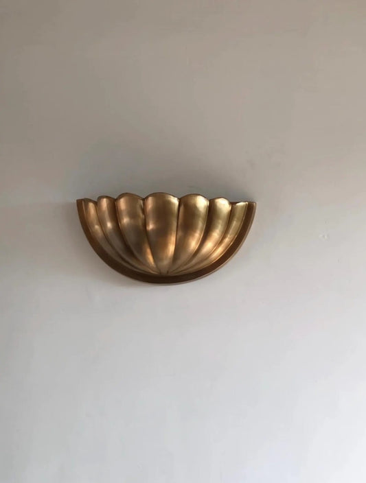 Front view of handcrafted scallop shell wall sconce