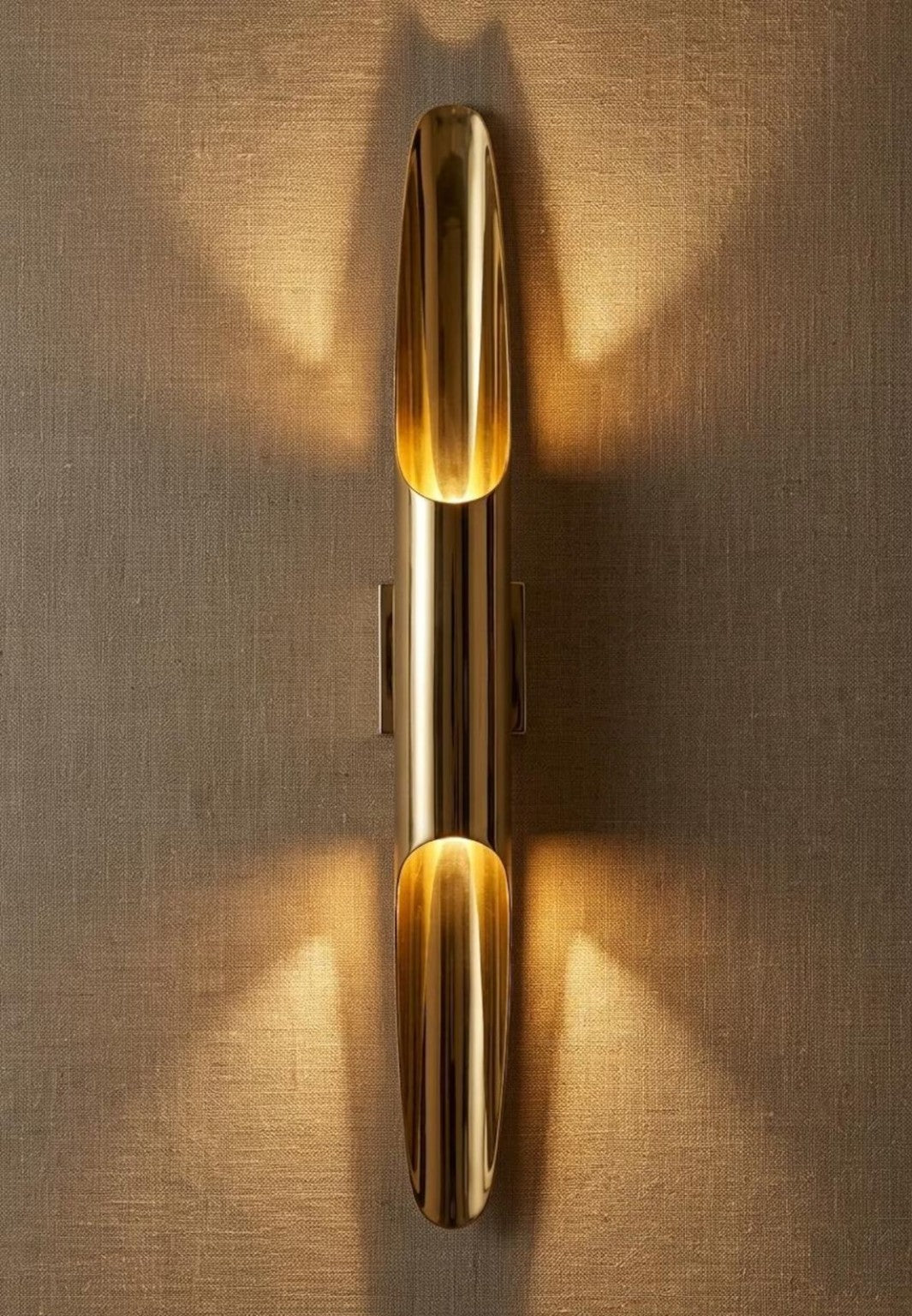 Sculptural brass tube wall sconce in brushed brass finish