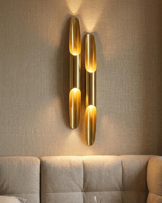 Pair of sculptural brass tube wall sconces in a luxury interior