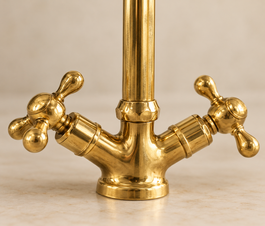 Close-up detail of handcrafted brass faucet cross handles