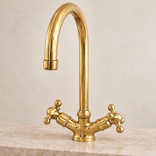 Handcrafted unlacquered brass gooseneck faucet with traditional cross handles
