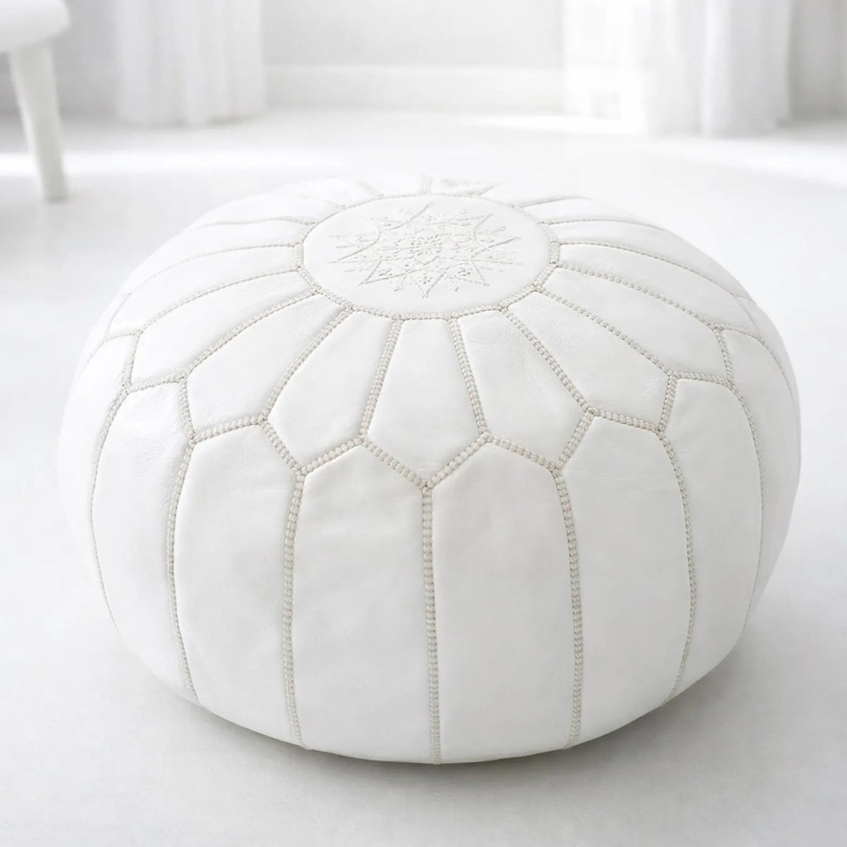 White round Moroccan leather pouf with hand-stitched panels